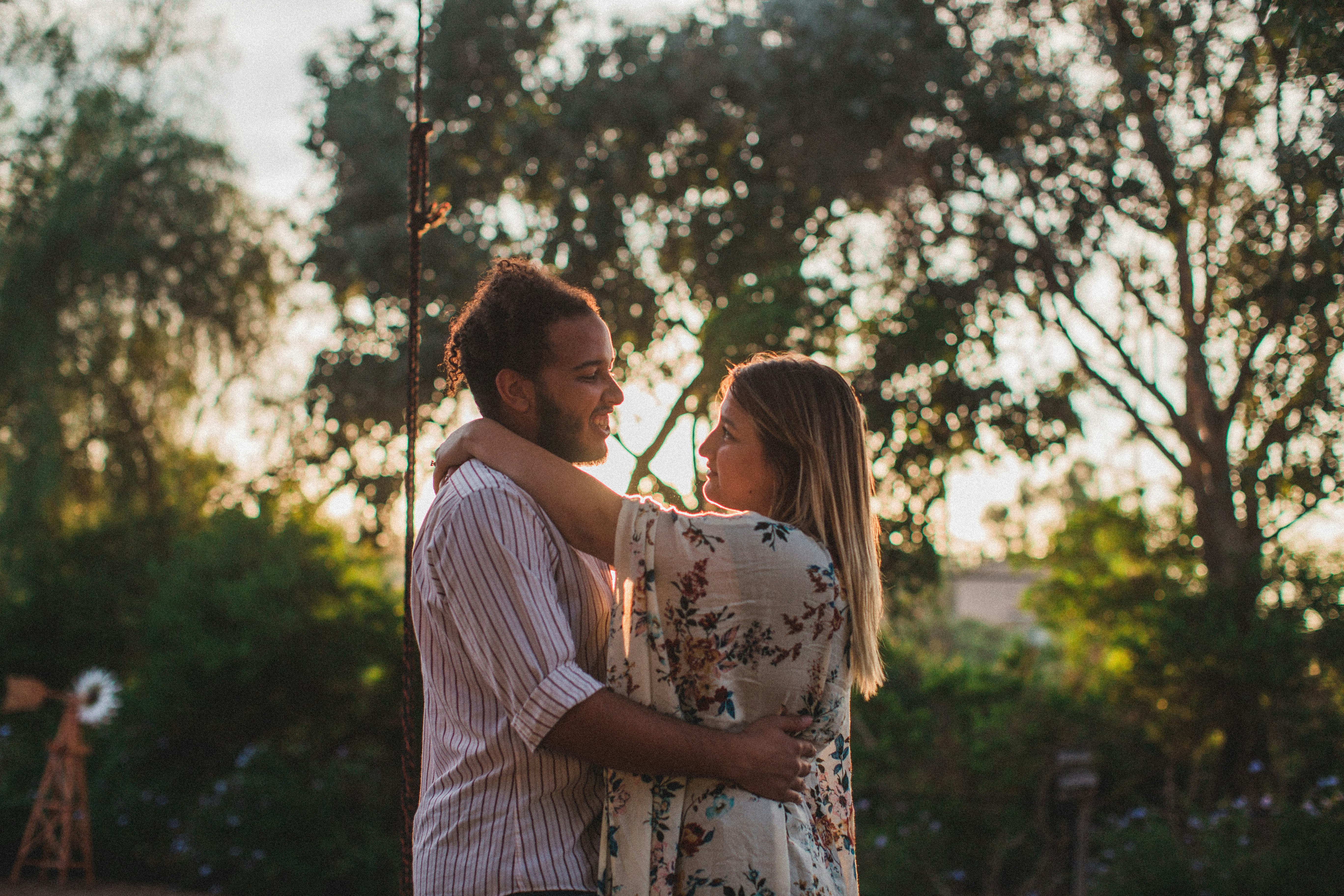 couple dancing beside trees during daytime